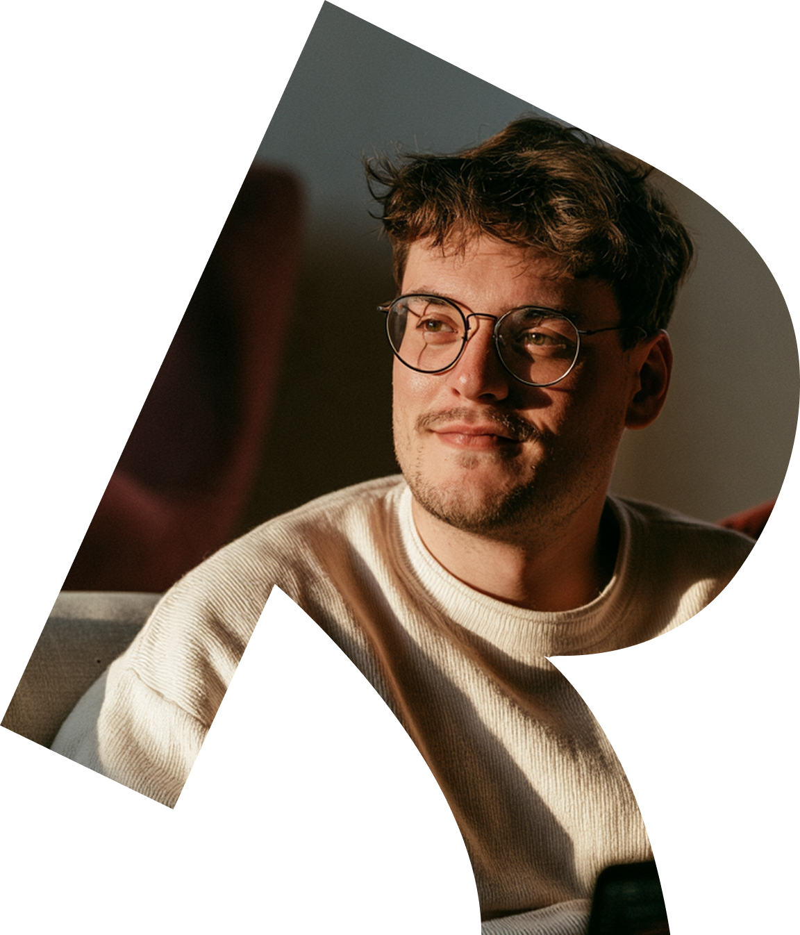 A smiling man in glasses, framed by the Roleo R