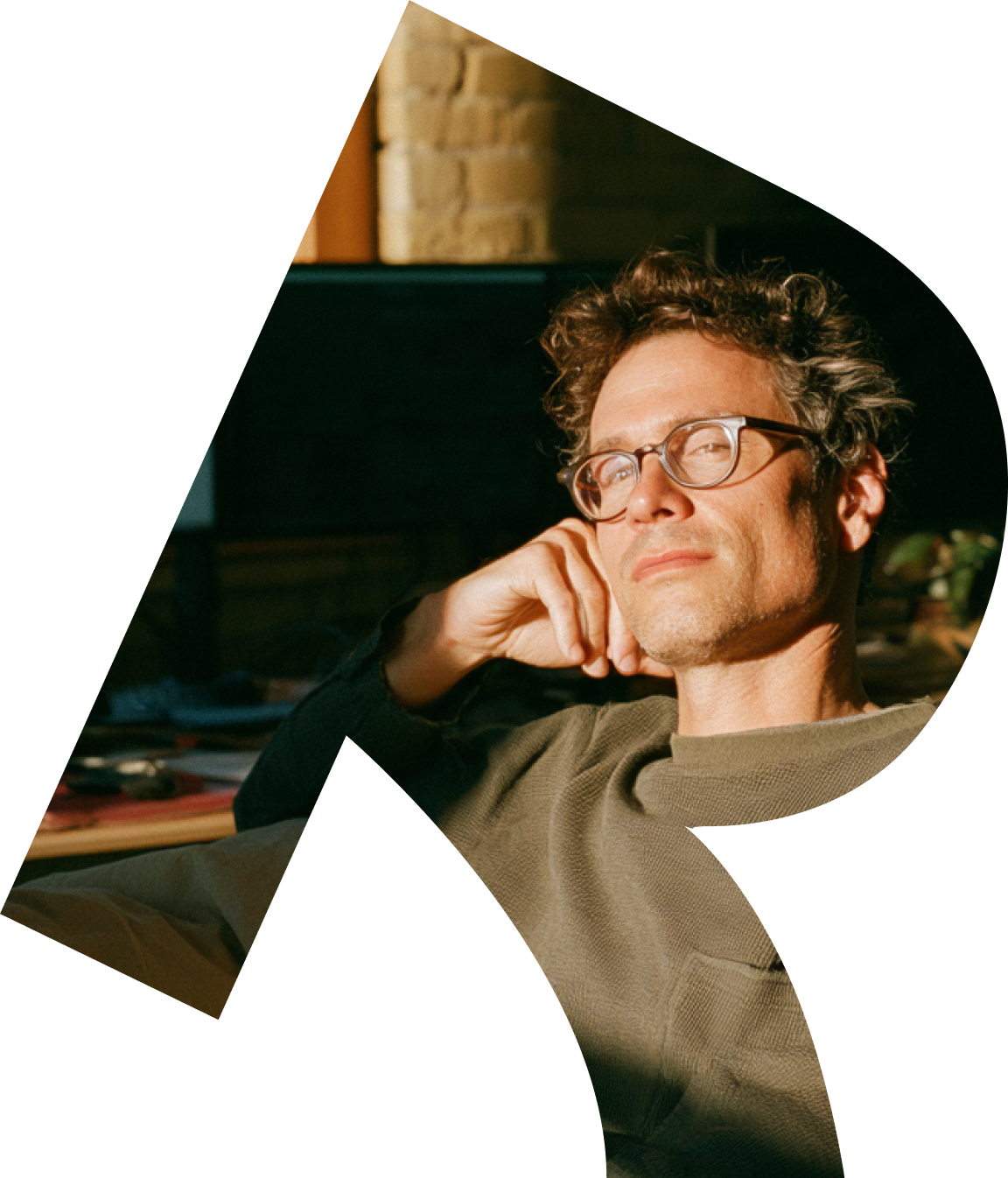 A smiling man in glasses, framed by the Roleo R